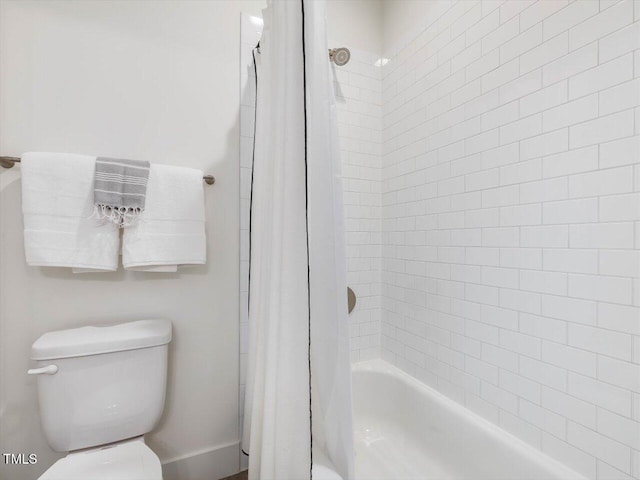 bathroom with shower / tub combo and toilet