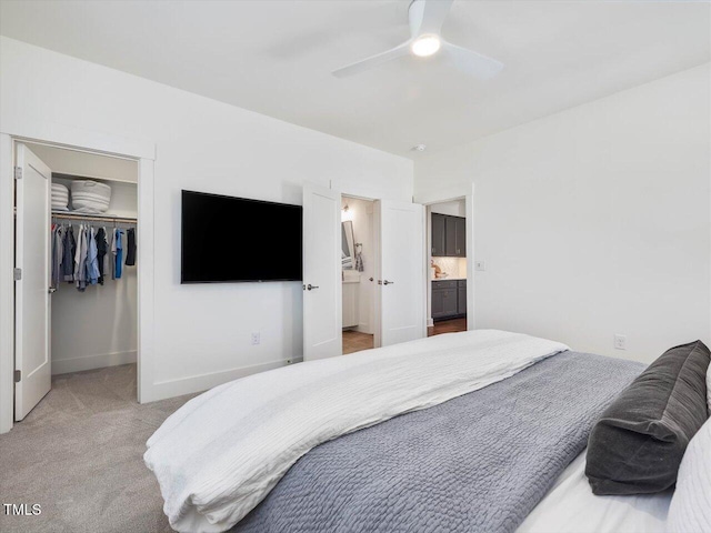 bedroom featuring ensuite bath, ceiling fan, carpet, a spacious closet, and a closet