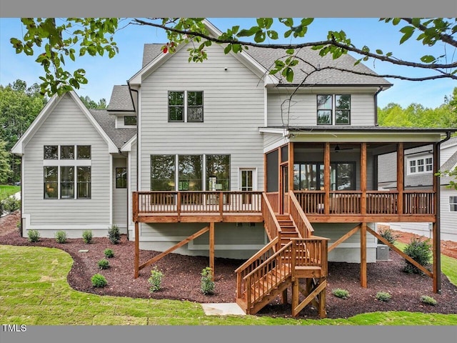 back of property with a wooden deck, a sunroom, and central air condition unit