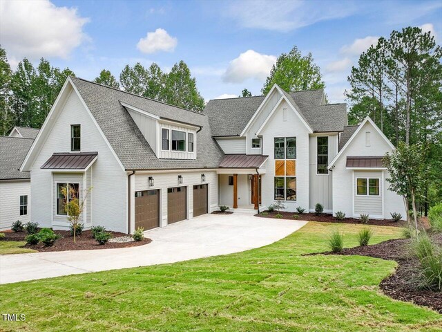 modern farmhouse with a garage and a front lawn