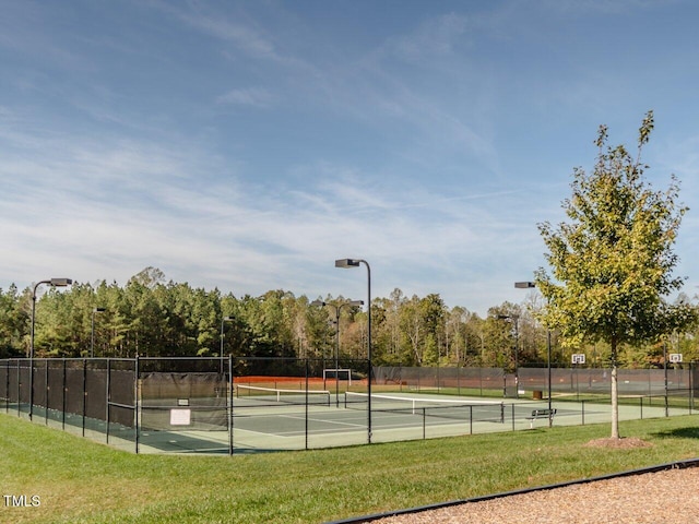 view of tennis court featuring a lawn