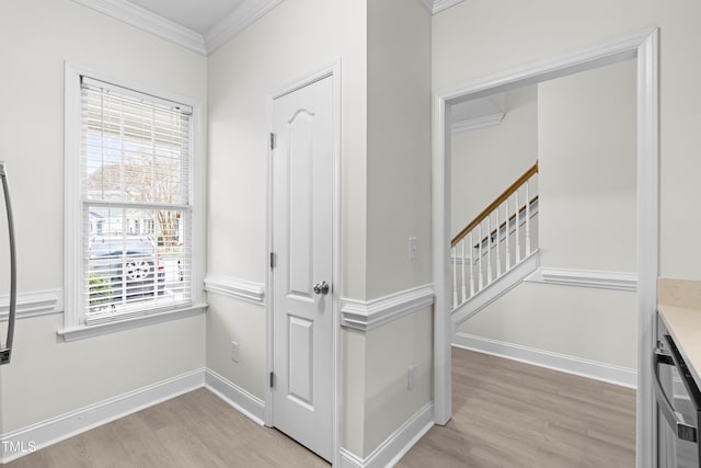 interior space featuring crown molding and light hardwood / wood-style floors