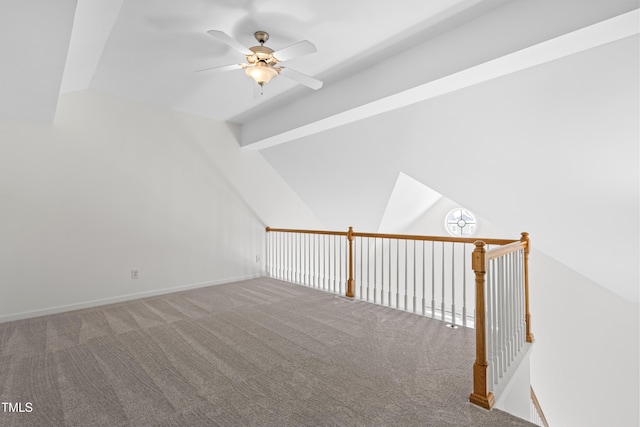 bonus room with lofted ceiling with beams, ceiling fan, and carpet