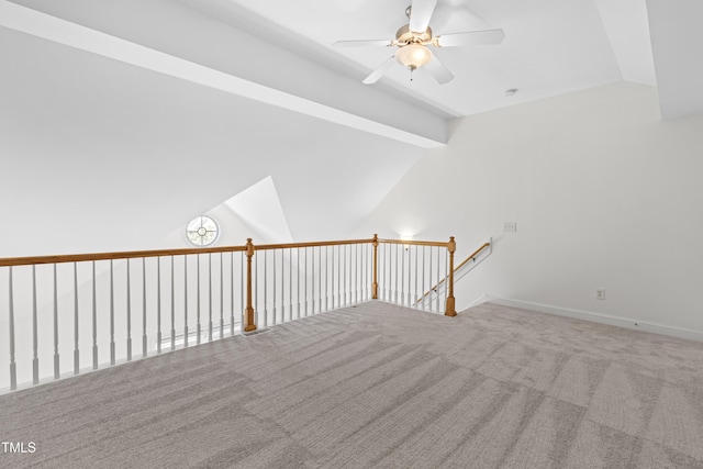 bonus room featuring lofted ceiling with beams, ceiling fan, and carpet