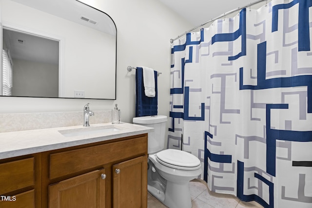 bathroom with vanity, tile patterned floors, and toilet