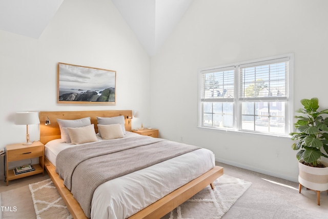 carpeted bedroom featuring high vaulted ceiling