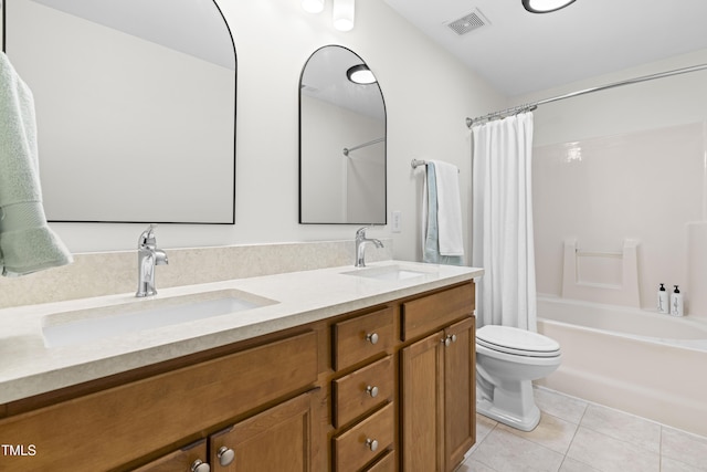 full bathroom featuring vanity, toilet, tile patterned flooring, and shower / bath combo