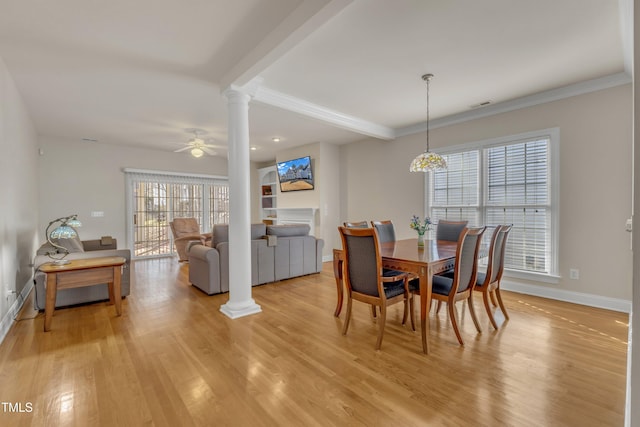 dining room featuring baseboards, visible vents, light wood finished floors, and ornate columns