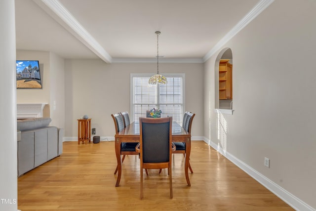 dining space with crown molding, light wood-type flooring, beam ceiling, and baseboards