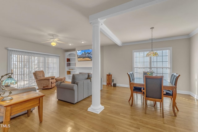 dining room featuring ornate columns, light wood-style flooring, plenty of natural light, and baseboards