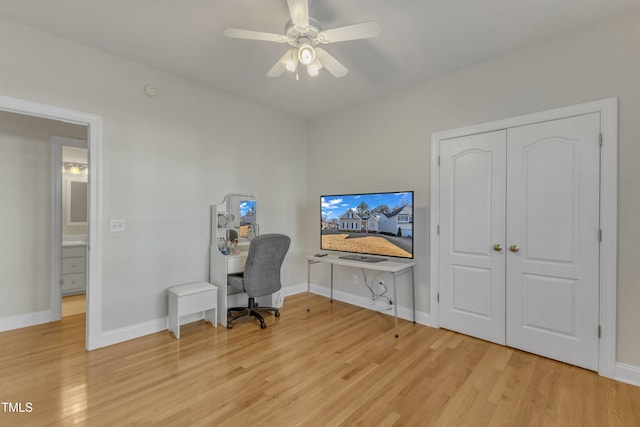 office with a ceiling fan, light wood-style flooring, and baseboards