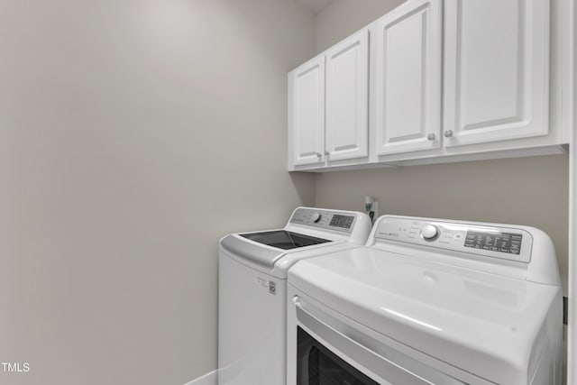 laundry room featuring cabinet space and washer and clothes dryer