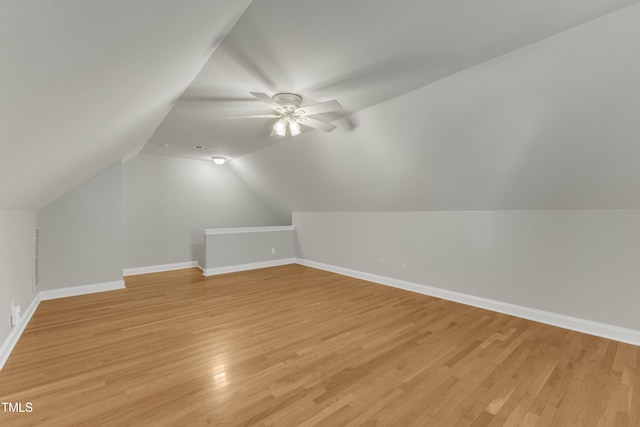 bonus room with light wood-type flooring, ceiling fan, and baseboards