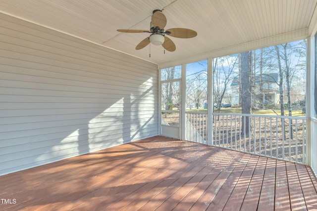 unfurnished sunroom featuring a healthy amount of sunlight and ceiling fan