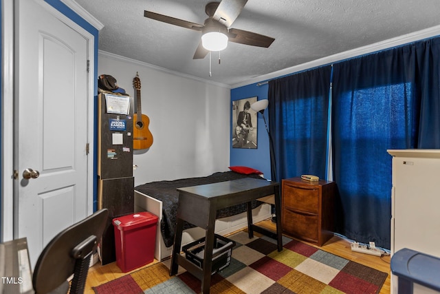 1167 John D Winstead Rd, Roxboro, NC 27574 - home office featuring a ceiling fan, wood finished floors, a textured ceiling, and crown molding