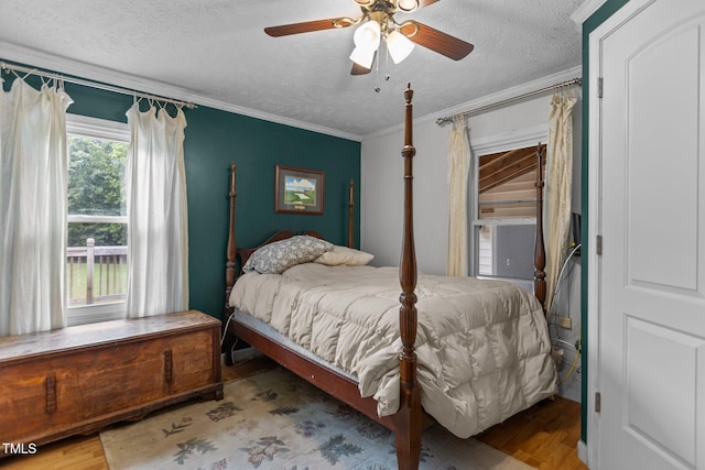 1167 John D Winstead Rd, Roxboro, NC 27574 - bedroom with ornamental molding, a textured ceiling, wood finished floors, and a ceiling fan