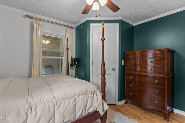 1167 John D Winstead Rd, Roxboro, NC 27574 - bedroom with wood finished floors, a textured ceiling, ceiling fan, ornamental molding, and connected bathroom