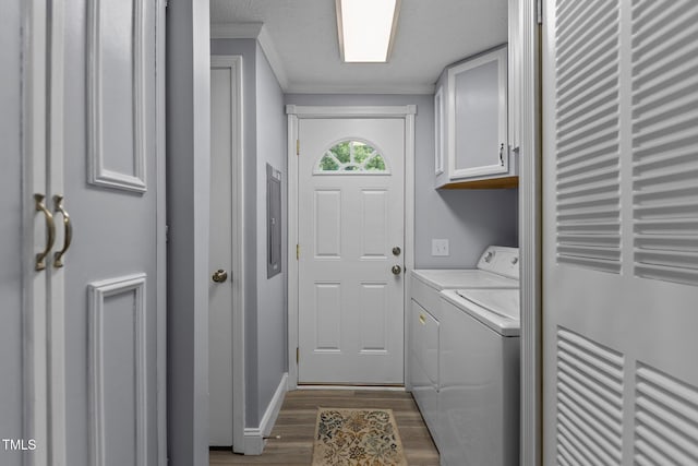 1167 John D Winstead Rd, Roxboro, NC 27574 - laundry area with cabinet space, washing machine and clothes dryer, ornamental molding, dark wood finished floors, and baseboards