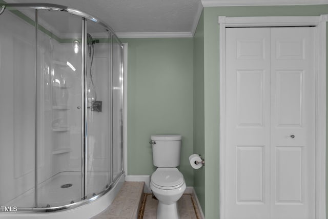 1167 John D Winstead Rd, Roxboro, NC 27574 - bathroom with a stall shower, toilet, baseboards, ornamental molding, and tile patterned floors