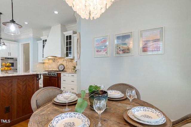 dining room featuring ornamental molding and an inviting chandelier