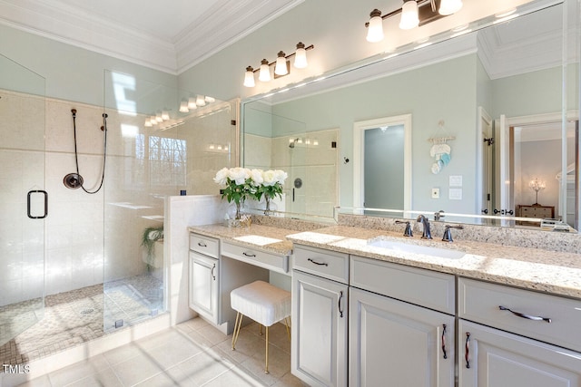 bathroom featuring tile patterned floors, ornamental molding, a shower with door, and vanity