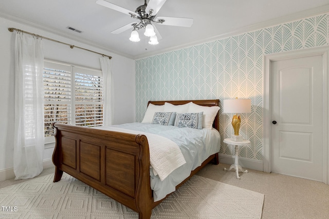 bedroom with crown molding, light colored carpet, and ceiling fan