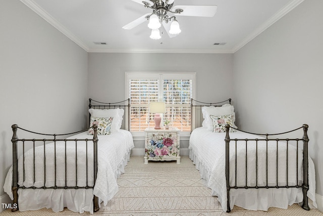 carpeted bedroom with ceiling fan and ornamental molding