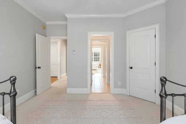 bedroom with crown molding and light colored carpet