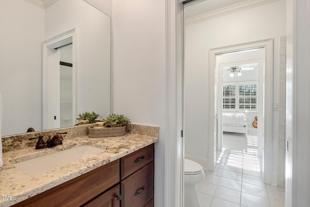 bathroom with vanity, tile patterned flooring, crown molding, and toilet