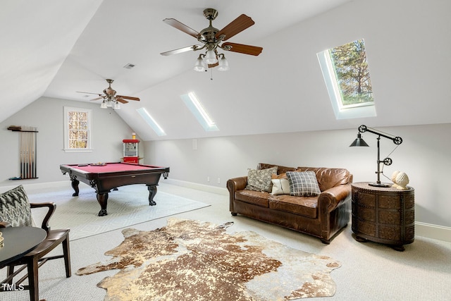 game room with ceiling fan, billiards, lofted ceiling with skylight, and light carpet