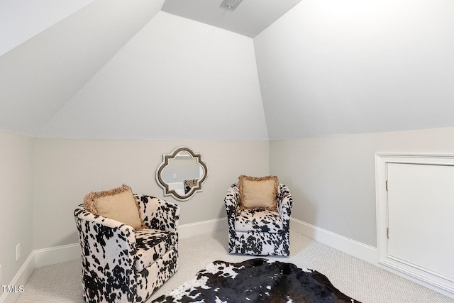 living area featuring lofted ceiling and carpet flooring