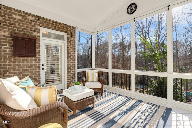 sunroom / solarium featuring vaulted ceiling