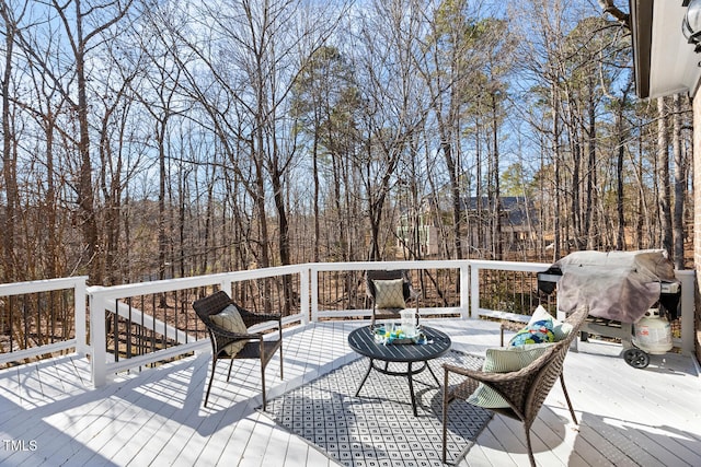 wooden deck featuring a grill