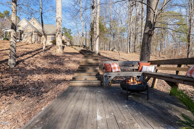 wooden terrace with a fire pit