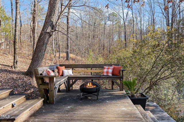 wooden deck with an outdoor fire pit