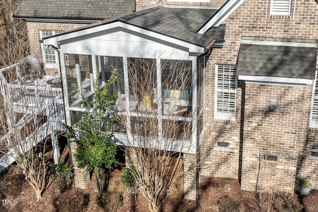 view of side of home with a sunroom