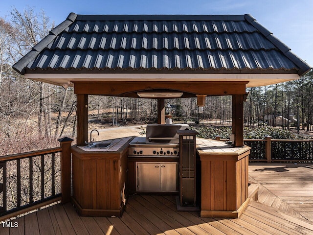 deck featuring area for grilling, sink, and exterior kitchen