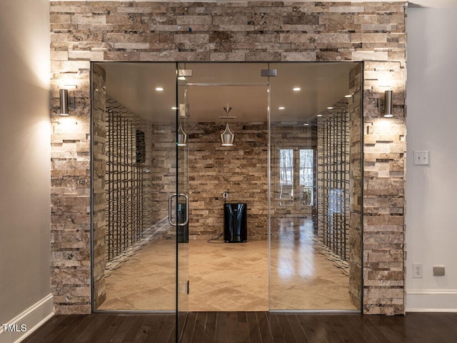 wine room with hardwood / wood-style flooring