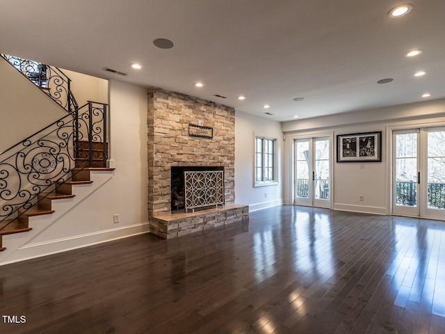 unfurnished living room featuring a wealth of natural light, dark hardwood / wood-style flooring, and french doors