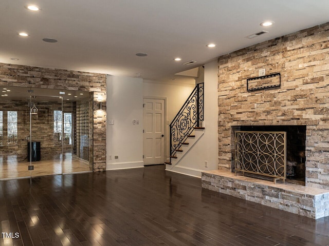 unfurnished living room with wood-type flooring and a fireplace