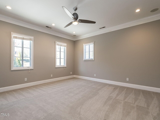 carpeted empty room featuring ceiling fan and ornamental molding