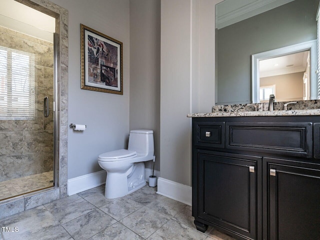 bathroom featuring vanity, crown molding, a shower with door, and toilet