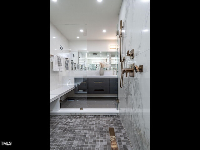 bathroom featuring vanity and an enclosed shower