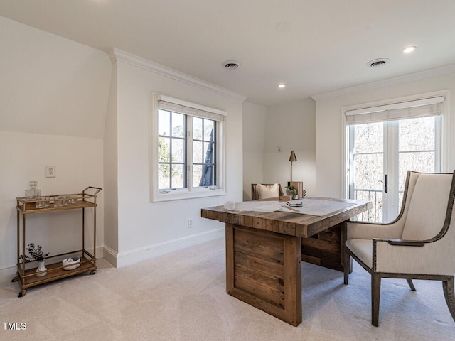 carpeted dining area featuring crown molding