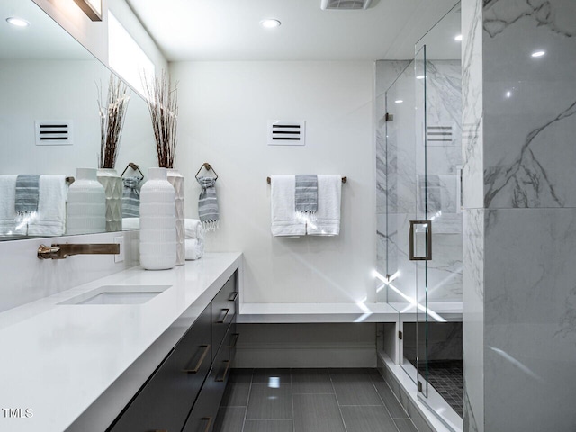 bathroom featuring vanity and an enclosed shower