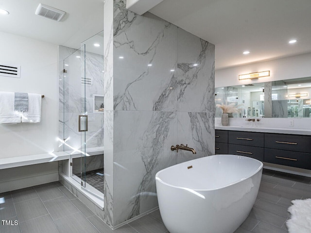 bathroom with vanity and separate shower and tub