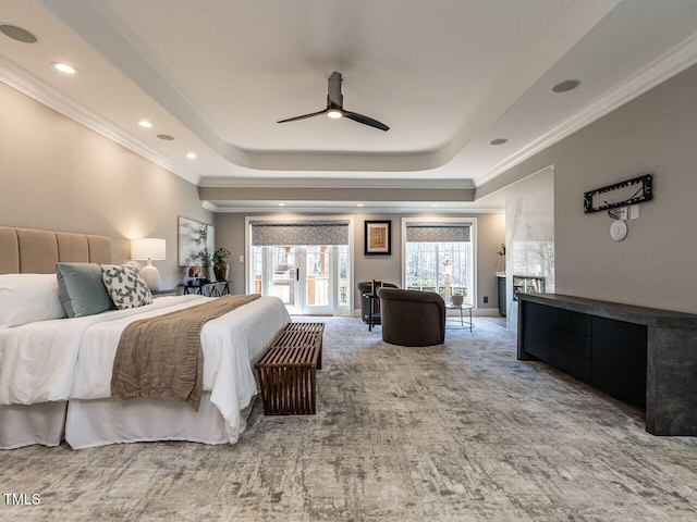 bedroom with ornamental molding, carpet flooring, a raised ceiling, and access to outside