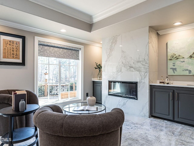 living room with crown molding and a fireplace