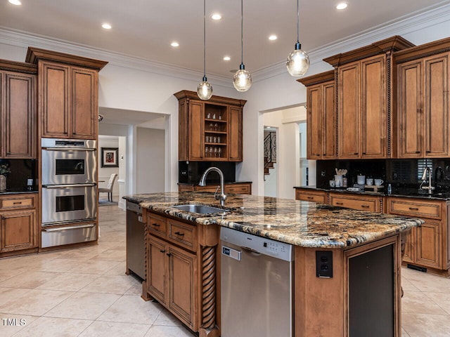 kitchen with sink, decorative light fixtures, a center island with sink, dark stone countertops, and stainless steel appliances