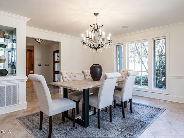 dining room with crown molding and a notable chandelier